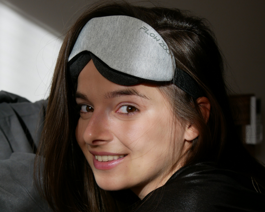 A woman waking up fully relaxed with a sleep mask